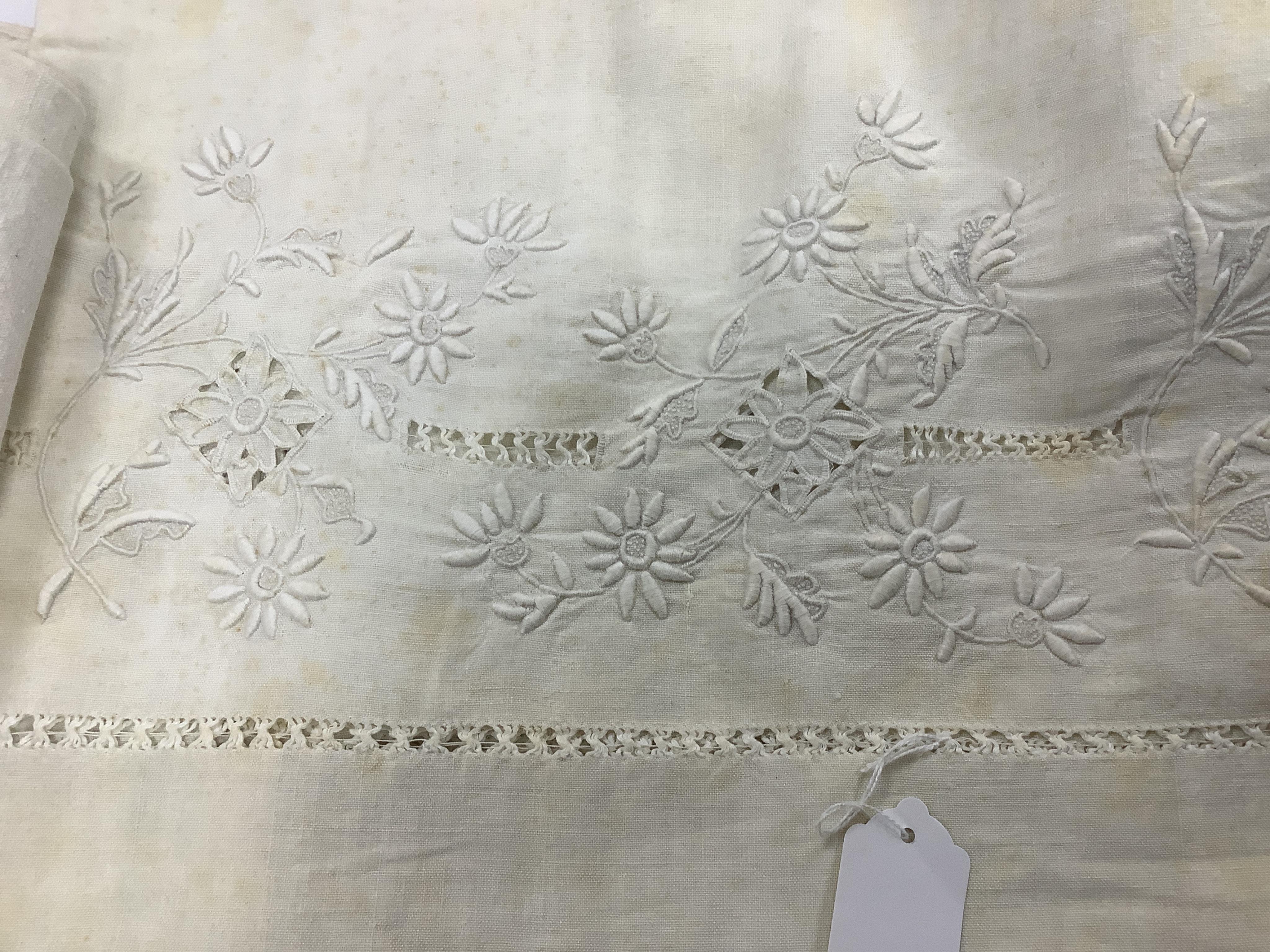 Four 19th century French provincial linen top sheets. Two with deep heavily floral embroidered turn backs, another with tear drops embroidered on the turn back, the other a narrower sheet with a single embroidered monogr